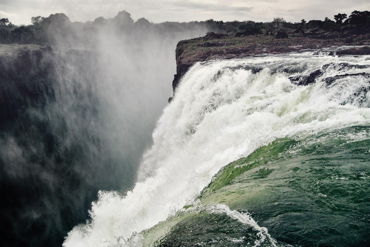 The Zambezi River pouring over the lip of Victoria Falls into the gorge below