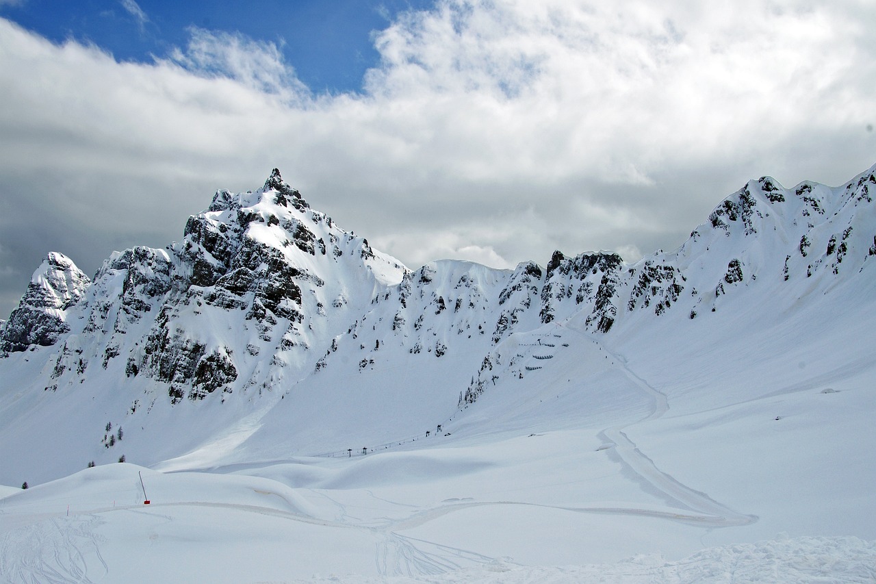 Pistes beneath the rocky peaks at Passo Padon in the Dolomiti Superski area